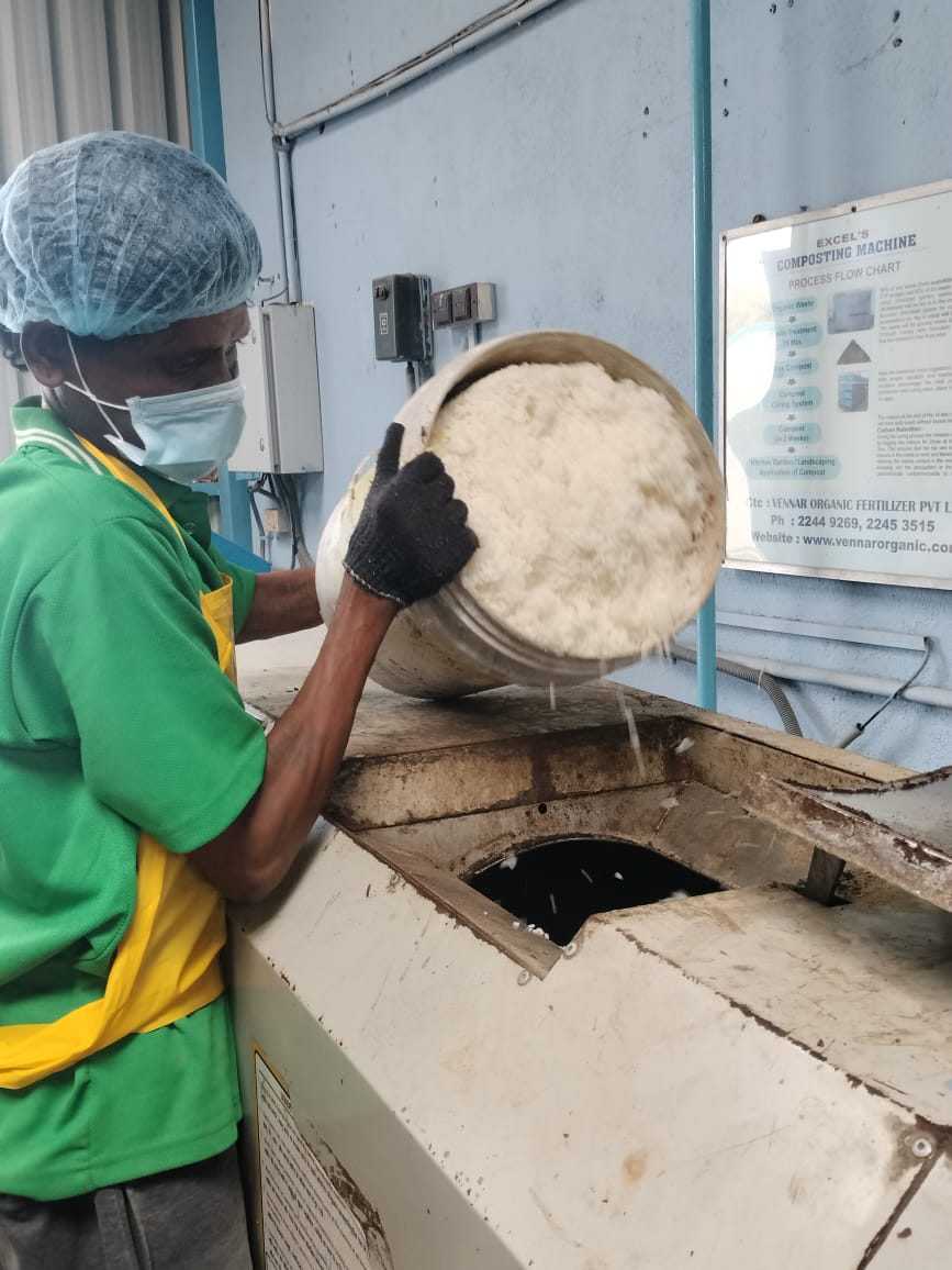 Feeding organic waste into the composting machine